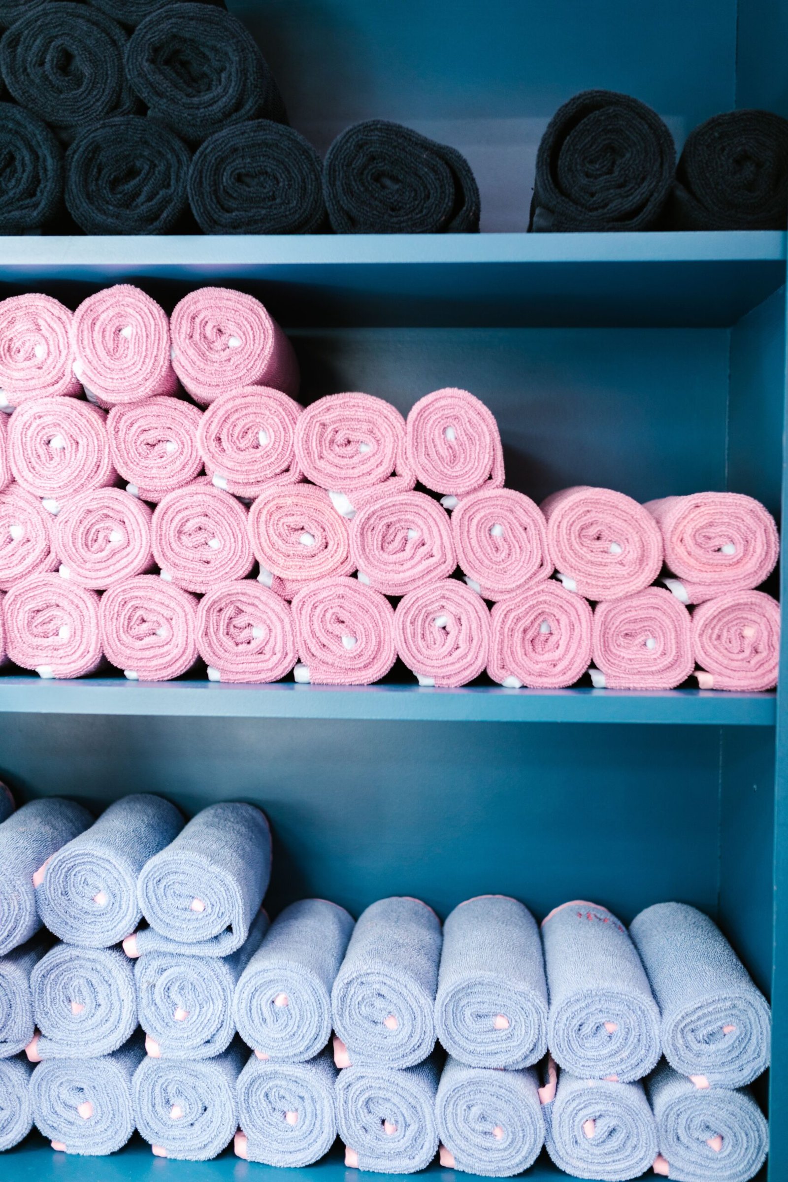 Housekeeper holding stack of towels